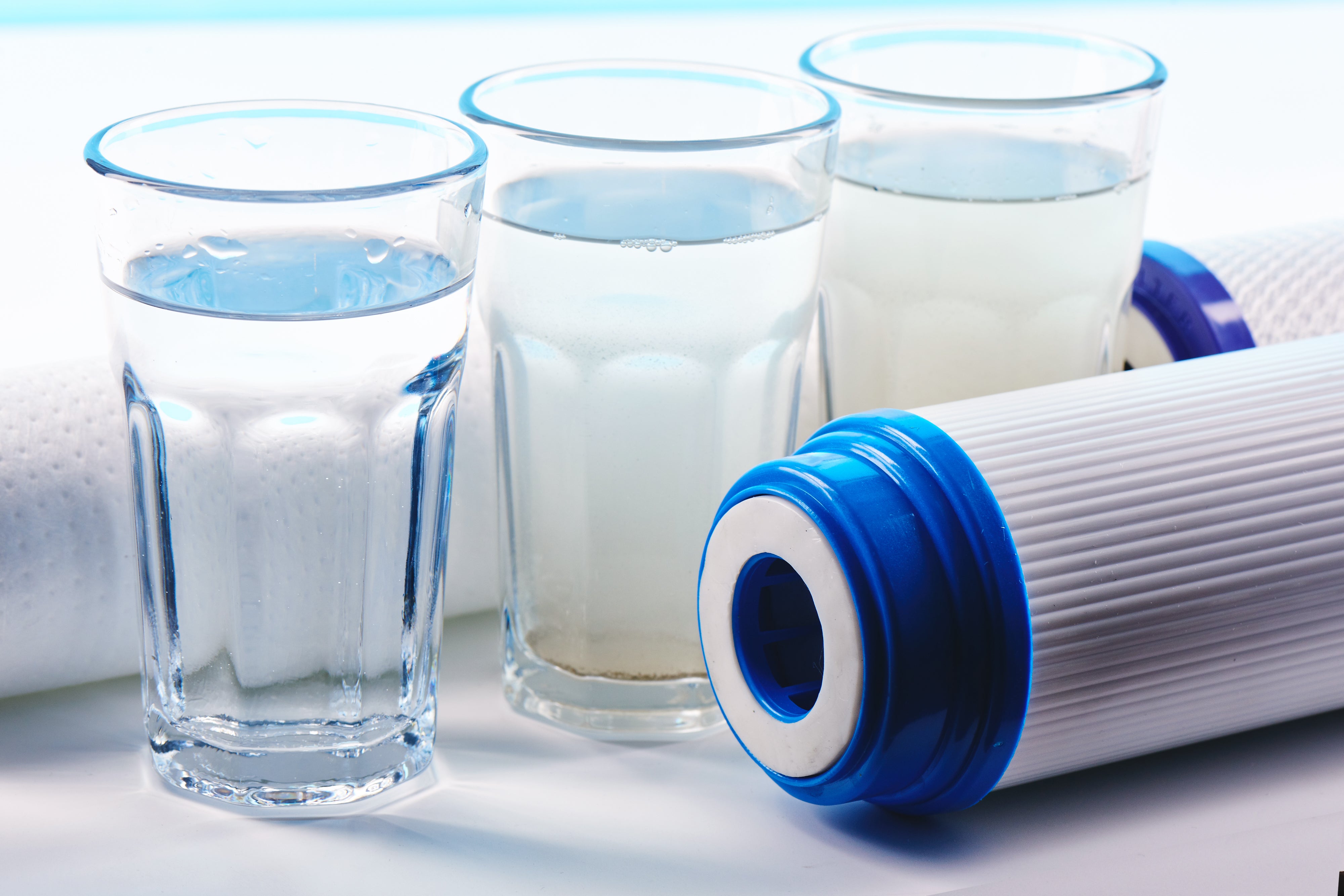Water filters next to glasses of water